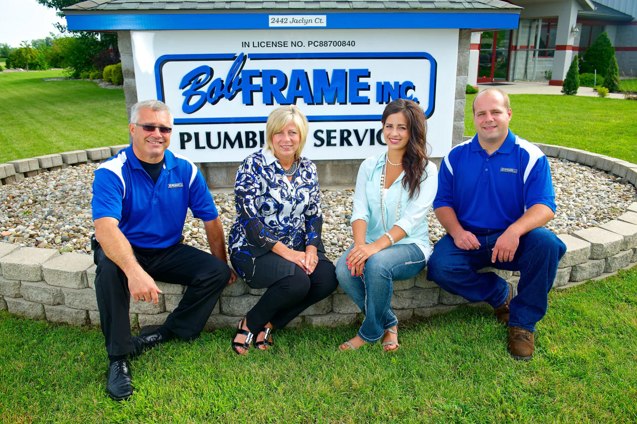 Members of the Frame family in front of the Bob Frame Plumbing sign