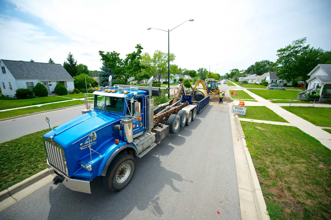 A Bob Frame Plumbing vac truck on a residential street